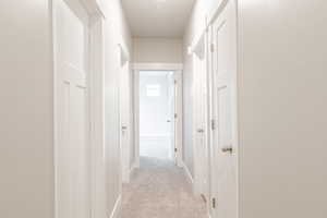 Hallway with light carpet