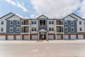 Townhome / multi-family property featuring a balcony and a garage