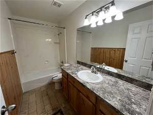 Full bathroom featuring vanity with extensive cabinet space,  shower combination, tile floors, and toilet