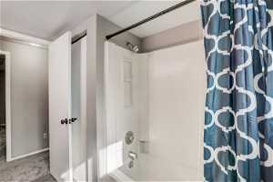 Bathroom featuring shower / bath combination with curtain