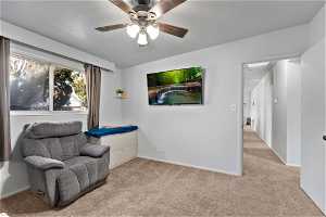 Sitting room with light carpet and ceiling fan