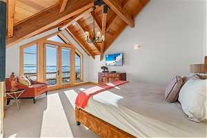 Carpeted bedroom featuring access to outside, wooden ceiling, a chandelier, a water view, and beam ceiling