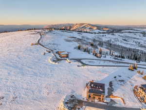 Snowy aerial view featuring a mountain view