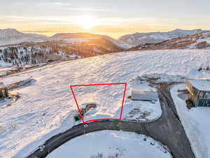 Snowy aerial view featuring a mountain view