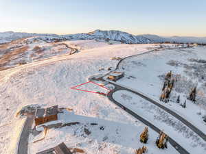 Snowy aerial view featuring a mountain view