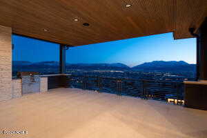 View of patio with a balcony and a mountain view