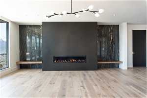 Unfurnished living room with a large fireplace and hardwood / wood-style flooring