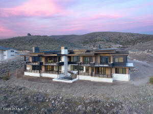 Back house at dusk featuring a mountain view