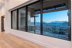 Unfurnished room with a mountain view and hardwood / wood-style floors