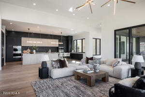 Living room with hardwood / wood-style floors and a towering ceiling