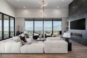 Living room featuring hardwood / wood-style flooring and a notable chandelier