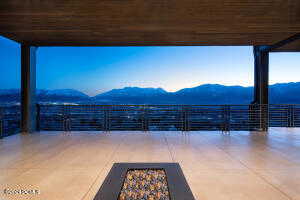 View of patio with a mountain view and a balcony