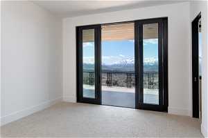 Doorway to outside featuring a wealth of natural light and carpet flooring
