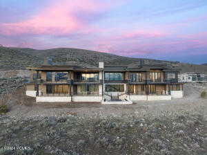 Back house at dusk with a mountain view and a patio