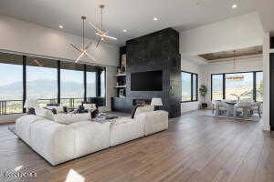 Living room with a notable chandelier, a fireplace, and hardwood / wood-style flooring