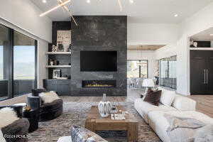 Living room with a fireplace and hardwood / wood-style flooring