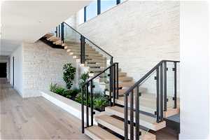 Staircase featuring hardwood / wood-style floors