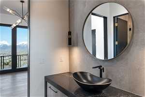 Bathroom featuring hardwood / wood-style flooring, french doors, a mountain view, and vanity with extensive cabinet space