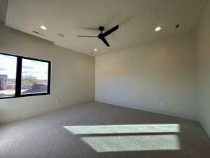 Carpeted empty room with ceiling fan