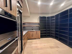 Kitchen with light hardwood / wood-style flooring