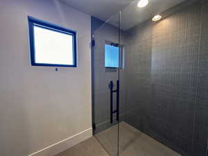 Bathroom featuring a tile shower and tile patterned floors