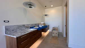 Bathroom with ceiling fan, sink, vaulted ceiling, and tile patterned flooring