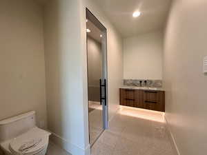 Bathroom featuring vanity and toilet