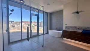 Bathroom with sink, plus walk in shower, and a wall of windows