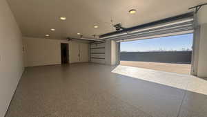 Garage featuring a water view and a garage door opener