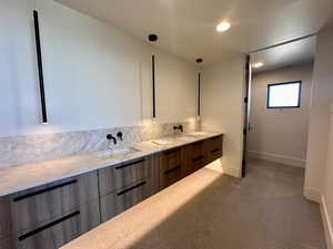 Bathroom with tile patterned flooring and vanity