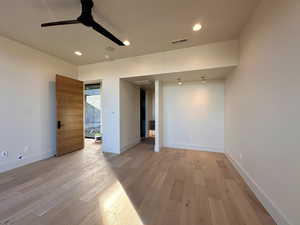 Unfurnished room with ceiling fan and light hardwood / wood-style flooring