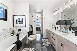 Primary Bathroom featuring plenty of natural light, double vanity, plus walk in shower, and tile flooring
