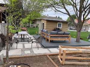 View of patio featuring a wooden deck and an outdoor hangout area