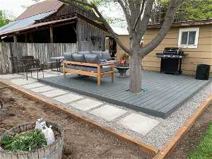 Wooden deck featuring grilling area and an outdoor living space