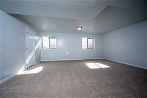 Carpeted empty basement  bedroom with plenty of natural light