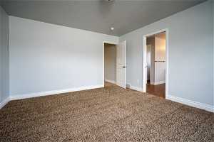 Unfurnished bedroom with carpet and a textured ceiling