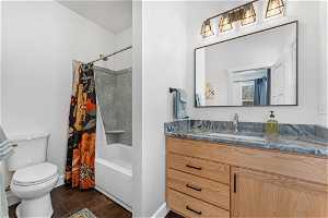 Full bathroom featuring vanity, toilet, shower / bathtub combination with curtain, and tile flooring