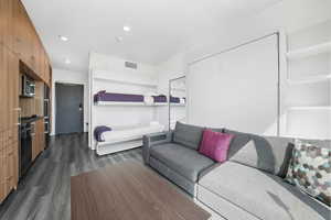Living room featuring dark wood finished floors and recessed lighting