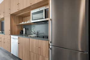 Kitchen featuring appliances with stainless steel finishes, open shelves, modern cabinets, and light brown cabinets