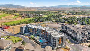 Aerial view of a mountain backdrop and a golf course