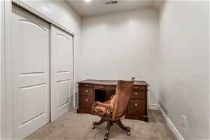 Home office with light carpet