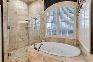 Bathroom featuring plenty of natural light and shower with separate bathtub