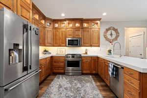 Kitchen featuring kitchen peninsula, high quality appliances, and sink