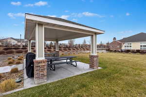 View of the nearby BBQ area, complete with a covered patio. Just in front of this space, you'll find a community garden.
