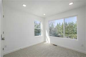 2nd bedroom room with light colored carpet