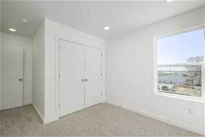2nd bedroom with a closet and light colored carpet