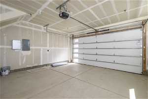 Garage featuring a garage door opener and EV outlet
