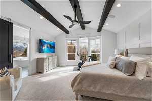 Carpeted bedroom featuring lofted ceiling with beams, ceiling fan, and multiple windows