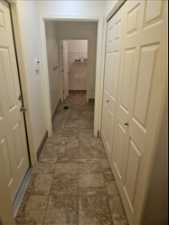 Hallway with dark tile flooring