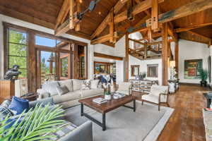 Living room featuring high vaulted ceiling and wood ceiling